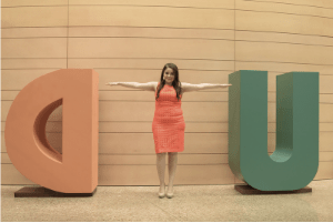 A student forms the T in a UTD display